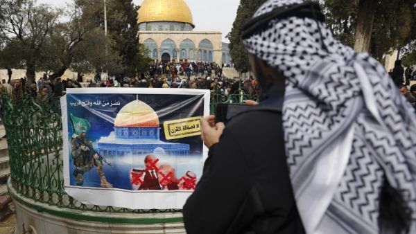 A banner placed by Hamas with a slogan reading in Arabic: "no to the deal of the century" (US Middle East peace plan) is pictured as Palestinian Muslim worshippers gather at the al-Aqsa mosque compound in the Old City of Jerusalem, on February 14, 2020. AHMAD GHARABLI / AFP
