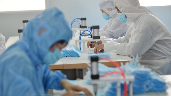 This photo taken on February 18, 2020 shows workers making face masks to satisfy increased demand during China's COVID-19 coronavirus outbreak, at a factory in Nanjing, in China's Jiangsu province. AFP