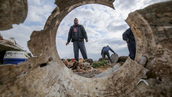 Palestinians salvage belongings from the site of an Israeli airstrike east of Khan Yunis in the southern Gaza Strip, on February 25, 2020. AFP