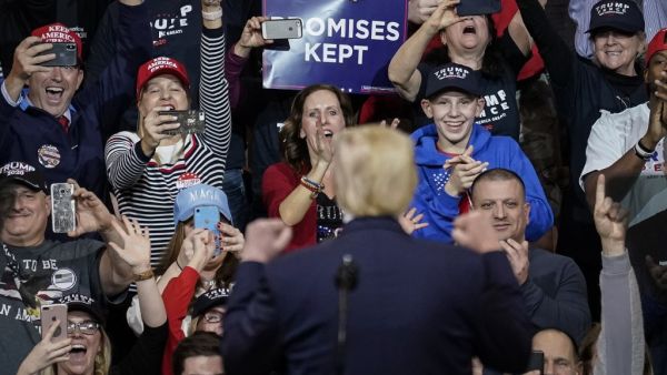 Supporters cheer as U.S. President Donald Trump arrives for a "Keep America Great" rally at Southern New Hampshire University Arena on February 10, 2020 in Manchester, New Hampshire. New Hampshire will hold its first in the national primary on Tuesday. Drew Angerer/Getty Images/AFP