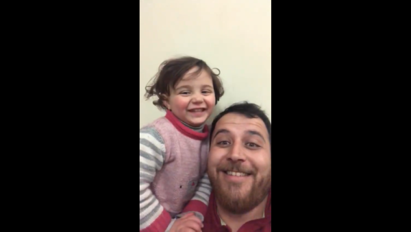 Abdullah Mohammad [R] taught his daughter the 'laughing game' to cope [Screenshot]