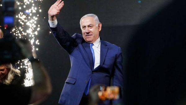 Israeli Prime Minister Benjamin Netanyahu greets supporters at his Likud Party headquarters in the Israeli coastal city of Tel Aviv on election night, early on April 10. (AFP)