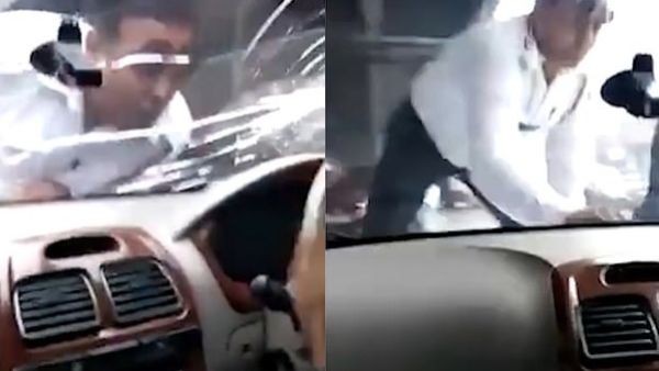 Footage shows the constable pointing to the driver through the windscreen in the Nangloi area of New Delhi, India. (News Lion)
