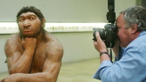 A photographer takes pictures of the reconstruction of Neanderthal man’s ancestor displayed in Halle, eastern Germany.( Photograph: Sebastian Willnow/AFP/Getty Images)