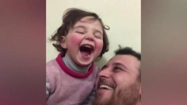 'Laugh at the Fireworks!' Syrian Father Makes Up a Game to Comfort His Daughter as Bombs Fall