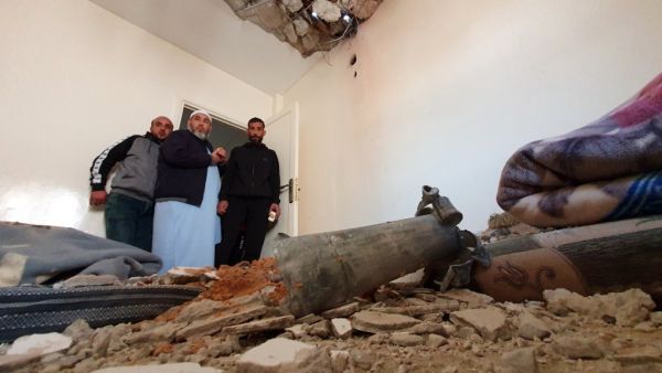 This picture taken on February 28, 2020 shows people inspecting the damage inside a building following a rocket attack by forces loyal to eastern Libyan strongman Khalifa Haftar, at a residential area in the government of national accord (GNA)-held capital Tripoli. AFP/File