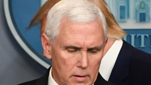 US President Donald Trump walks past US Vice President Mike Pence (L) during a press conference on the COVID-19, coronavirus, outbreak at the White House in Washington, DC on February 29, 2020. The number of novel coronavirus cases in the world rose to 85,919, including 2,941 deaths, across 61 countries and territories by 1700 GMT on Saturday, according to a report gathered by AFP from official sources. Roberto SCHMIDT / AFP