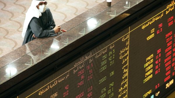 A Kuwaiti trader wearing a protective mask follows the market at the Boursa Kuwait stock exchange in Kuwait City on March 1, 2020. AFP