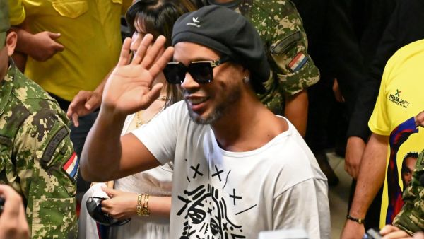 Brazilian ex-football star Ronaldinho Gaucho waves upon arriving at Silvio Pettirossi International Airport in Luque, near Asuncion, on March 4, 2020. Ronaldinho arrived in Paraguay to present his latest book "Genio en la Vida" and a health programme for girls and boys.  Norberto DUARTE / AFP