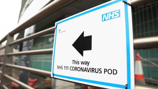 A sign directs directs patients to an NHS 111 Coronavirus Pod testing service area for COVID-19 assessment at University College Hospital in London on March 5, 2020. The number of confirmed cases of novel coronavirus COVID-19 in the UK rose to 85 on March 4, with fears over the outbreak delaying the global release of the new James Bond movie and causing lack of demand for air travel that has proved the final nail in the coffin for British regional airline Flybe which went into administration on March 5.  IS