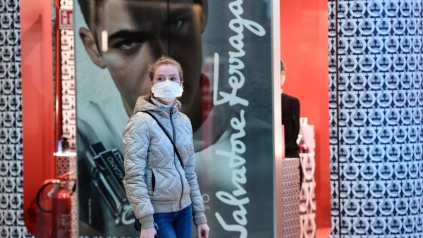 A passenger wearing a protective face mask looks on in Milano Centrale railway station in Milan on March 8, 2020, after millions of people were placed under forced quarantine in northern Italy as the government approved drastic measures in an attempt to halt the spread of the COVID-19 outbreak, caused by the novel coronavirus that is sweeping the globe. On top of the forced quarantine of 15 million people in vast areas of northern Italy until April 3, the government has also closed schools, nightclubs and c