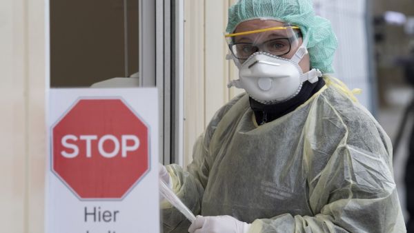 A medical assistant holds a test kit for the novel coronavirus SARS-CoV-2, which can cause COVID-19, at the new "Drive-In" in Nuertingen, southern Germany, on March 9, 2020, where people can get a coronavirus test from their car, during a presentation of the drive-in for the media. The number of coronavirus cases in Germany has passed 1,000, official data from the Robert Koch Institute disease control centre showed. THOMAS KIENZLE / AFP