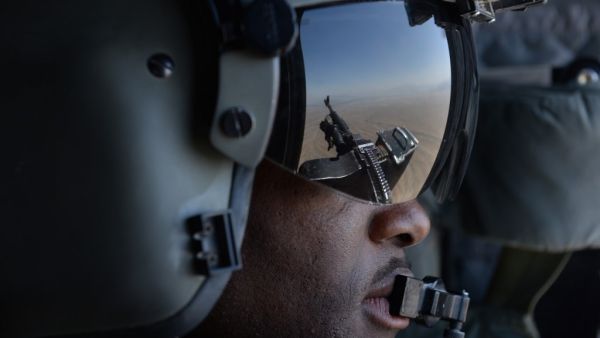 In this file photo taken on August 11, 2014, a US soldier, part of the NATO-led International Security Assistance Force (ISAF), looks out onboard a Chinook helicopter over the Gardez district of Paktia province. American forces have started pulling out of two bases in Afghanistan, a US official said on March 10, the day peace talks between Kabul and the Taliban were due to start despite widespread violence and a political crisis. The United States is keen to end its longest-ever conflict, and under the term