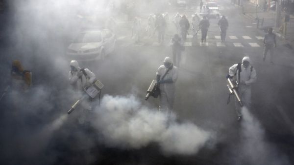 Iranian Firefighters disinfect streets in the capital Tehran in a bid to halt the wild spread of coronavirus on March 13 2020. Iranian forces will clear the streets nationwide within 24 hours and all citizens will be checked for the new coronavirus in a bid to halt its spread, the military said. AFP