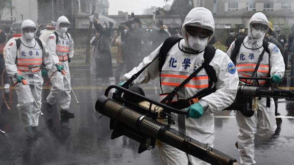 Soldiers from the military’s chemical units take part in a drill organised by the New Taipei City government to prevent the spread of the COVID-19 coronavirus, in Xindian district on March 14, 2020. Over 450 medical staff, community volunteers, government employees and military personnel took part in the drill. Despite being so close to the original outbreak in mainland China, Taiwan has just 48 confirmed cases of the Covid-19 disease with one death.  Sam Yeh / AFP