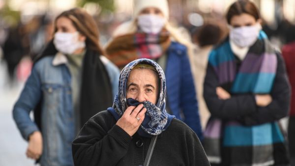 People wear protective face masks as they walk along Istiklal Avenue as the nation tries to contain the novel coronavirus, COVID-19, in Istanbul on March 17,2020. AFP/File