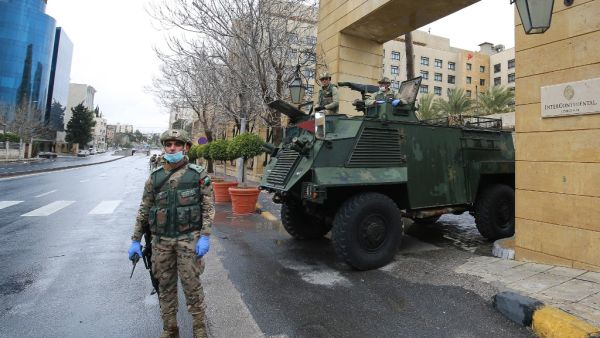 Jordanian soldiers keep watch on March 18, 2020 at an empty avenue in the capital Amman as Jordan takes measures to fight the spread of the coronavirus COVID-19. Khalil MAZRAAWI / AFP
