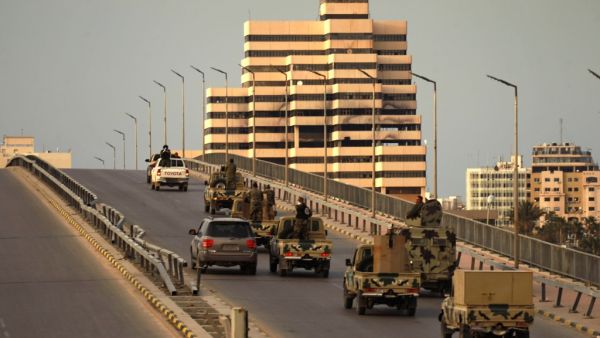 Fighters of a military battalion loyal to Libyan General Khalifa Hafta patrol the streets in the eastern city of Benghazi during a state of emergency to combat the coronavirus disease (COVID-19) outbreak, on March 21, 2020. Abdullah DOMA / AFP