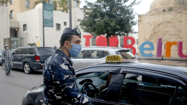 A Lebanese security officer mans a checkpoint to implement a curfew on motorcycles and vehicles with more than two passengers in the capital Beirut, on March 23, 2020, amid lockdown measures to curb the spread of the coronavirus epidemic. PATRICK BAZ / AFP