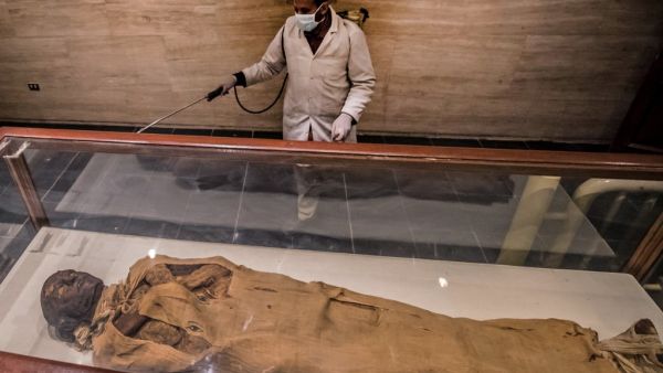A worker disinfects the Royal Mummies Hall at the Egyptian Museum in Cairo's landmark Tahrir Square amid the coronavirus COVID-19 pandemic, on March 23, 2020. Khaled DESOUKI / AFP
