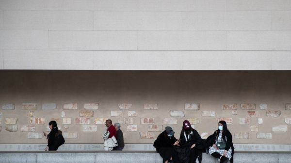 Tourists wearing a protective mask are seen at the Metropolitan Museum of Art on March 10, 2020 in New York City on March 12, 2020 in New York City. The museum announced it will be closed Friday because of the COVID-19 pandemic. Jeenah Moon/Getty Images/AFP Jeenah Moon / GETTY IMAGES NORTH AMERICA / AFP