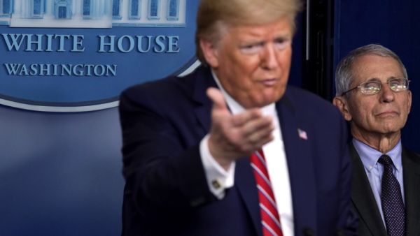 U.S. President Donald Trump speaks as Director of the National Institute of Allergy and Infectious Diseases Dr. Anthony Fauci looks on during a news briefing on the latest development of the coronavirus outbreak in the U.S. at the James Brady Press Briefing Room at the White House March 20, 2020 in Washington, DC. With deaths caused by the coronavirus rising and foreseeable economic turmoil, the Senate is working on legislation for a $1 trillion aid package to deal with the COVID-19 pandemic. President Trum