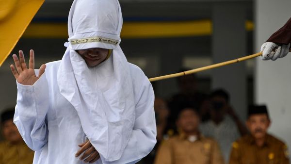 Dozens gathered to watch as the humiliated woman was whipped along with seven other victims outside a mosque in the provincial capital Banda Aceh (AFP)