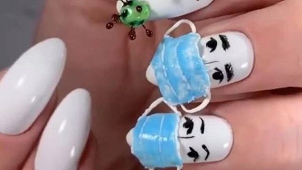 Dailonsy Nails, from Miami, shared their design which features a set of white acrylics and 3D replicas of medical masks and the virus  (Instagram)