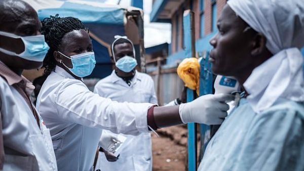 Staff of a NGO measuring a patient's body temperature in Nairobi, Kenya, to check for coronavirus yesterday (file image/AFP)
