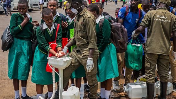 Secondary school students at a temporary hand-washing point, before they return home. The Rwandan Government has decided to send back all students of boarding schools after the first case of COVID-19 was found on March 13, in Kigali. (AFP/File)