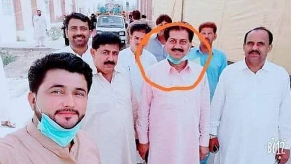 Pakistan has suspended six civil servants after they posed for a selfie with a coronavirus patient (circled) in a quarantine centre, an official said today (Dailymail)