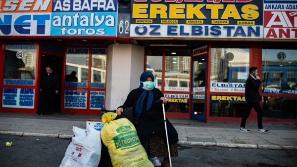 A woman wearing a protective face mask waits at the Esenler bus terminal in Istanbul, on March 14, 2020, during the outbreak of COVID-19, the new coronavirus. Turkey will halt flights with nine European countries the transport minister said on March 13, after having already shut all schools for two weeks and bar spectators from football matches through April, as part of Ankara's bid to contain the spread of the new coronavirus. Yasin AKGUL / AFP