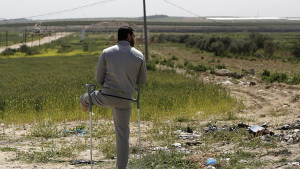 A disabled Palestinian man stands during an event marking Land Day near the Israel-Gaza border as mass rallies planned to commemorate the event were cancelled amid concerns about the spread of coronavirus disease (COVID-19), east of Gaza City, on March 30, 2020. MOHAMMED ABED / AFP