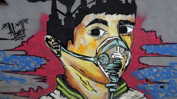 A picture taken on Mach 30, 2020 shows a mural depicting a mask-clad boy in front of the Zouk Thermal Power Plant, north of the Lebanese capital Beirut. JOSEPH EID / AFP