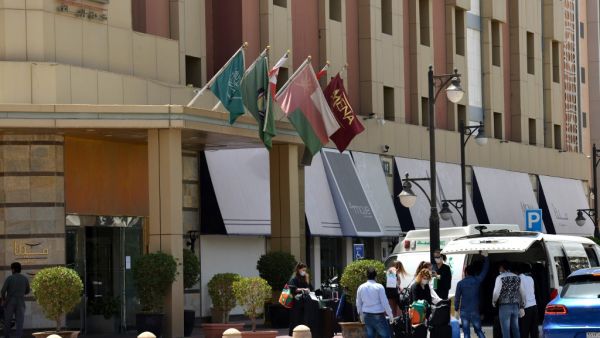 Mask-clad guests who were in quarantine depart the Mena Hotel in Riyadh on March 30, 2020. Saudi Arabia has quarantined thousands of people in hotels, some in luxury suites, to combat COVID-19, throwing a temporary lifeline to an industry struggling just months after tourist visas were launched. Faced with nearly 4,500 novel coronavirus infections -- the highest in the Gulf -- the petro-state has halted air travel, locked down cities and imposed nationwide curfews in a crisis that has dealt a blow to the na