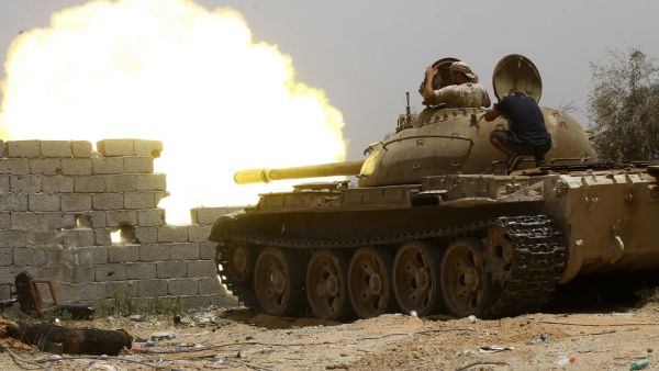 In this file photo taken on June 13, 2019, fighters loyal to the UN-recognised Government of National Accord (GNA) open tank fire from their position in the al-Sawani area south of the Libyan capital Tripoli during clashes with forces loyal to strongman Khalifa Haftar. AFP