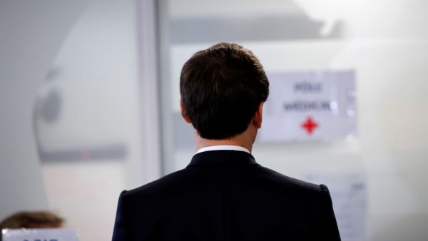 French President Emmanuel Macron visits the Crisis and Support Center at the French Foreign Affairs ministry, at Quai D’Orsay, in Paris, in order to give support and repatriation to French citizens abroad, on April 3, 2020. Francois Mori / POOL / AFP