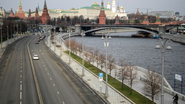A bicyclist rides on the empty embankment close to the Kremlin in central Moscow on April 3, 2020, amid the spread of the COVID-19, the novel coronavirus. Kirill KUDRYAVTSEV / AFP