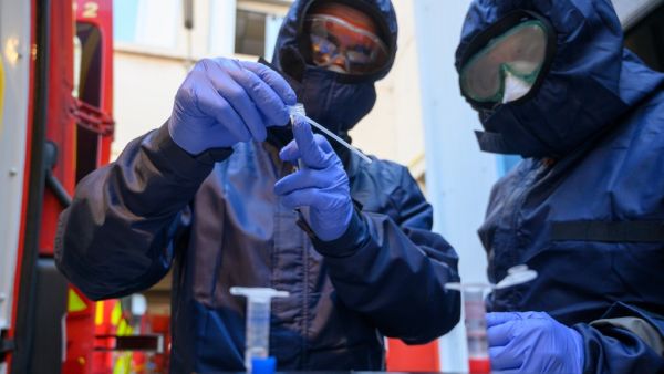 French firefighters from Marins Pompiers unit of Marseille wearing protective equipments as they working at the PCR machine on a mobile unit, which can detect the presence of SARS-CoV-2 in the environment after prelevment in Marseille on 03 April, 2020, during the strict lockdown in France to stop the spread of the novel coronavirus. AFP