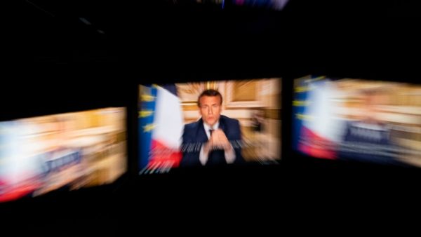 French President Emmanuel Macron is seen on multiple monitors in Paris, as he speaks from the Elysee Palace during a televised address to the nation on April 13, 2020, on the 28th day of a lockdown in France aimed at curbing the spread of the COVID-19 pandemic, caused by the novel coronavirus. The French president in a prime-time televised address announced the coronavirus lockdown in place since March 17, 2020, will go on until May 11, while also outlining how the country will take steps to recover.  Marti