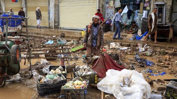 A Yemeni vendor looks at goods he managed to salvage from his stall, damaged by floods following heavy rains in the capital Sanaa, on April 14, 2020. Mohammed HUWAIS / AFP