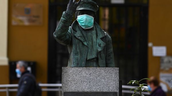 The statue of local legend Angela Rodriguez Hidalgo popularly known as 'the rocker granny', sports a face mask in Puente de Vallecas, one of the poorest districts in Madrid on April 20, 2020 during a national lockdown to prevent the spread of the COVID-19 disease. Spain said 399 people died of COVID-19 over the past 24 hours in what was the lowest daily number of deaths in four weeks, the government said. Gabriel BOUYS / AFP
