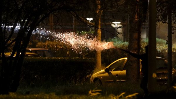 People fire fireworks during clashes in Villeneuve-la-Garenne, in the northern suburbs of Paris, on April 20, 2020. Tension with the police erupted again on the evening of April 20 in Villeneuve-la-Garenne near Paris, where a motorcycle accident involving the police had provoked the first clashes with residents two days before. GEOFFROY VAN DER HASSELT / AFP