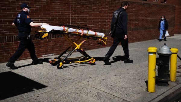 Medical workers walk with a stretcher outside of Montefiore Medical Center April 06, 2020 in the Bronx borough of New York City. AFP