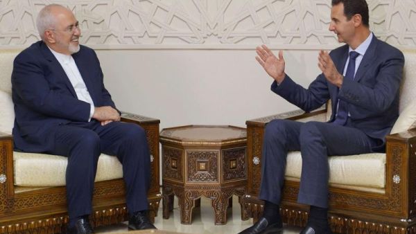 Iran's Foreign Minister Mohammad Javad Zarif (L) meeting with Syrian President Bashar al-Assad (R) in Damascus on September 3, 2018. (AFP)
