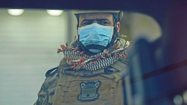 A mask-clad soldier stands guard in Iraq's southern city of Basra, (AFP) 