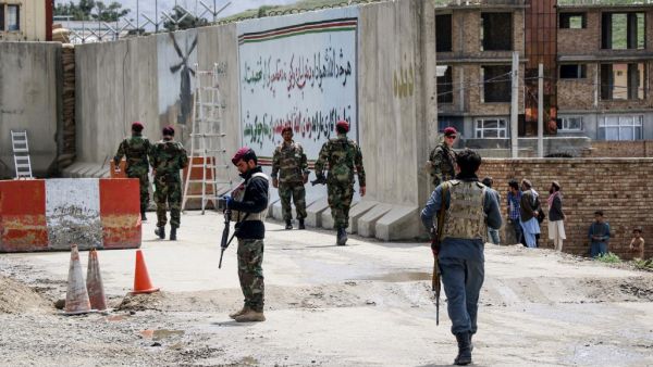 Security personnel gather near a military outpost at the site where a suicide bomber attack occurred, on the outskirts of Kabul on April 29, 2020. A suicide bomber killed at least three people and wounded 15 others after detonating explosives near a military outpost in Kabul on April 29, an official confirmed, in the first attack to rock the Afghan capital in weeks. STR / AFP