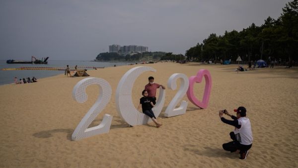 In a photo taken on May 2, 2020 holiday-makers visit a beach in Sokcho, on South Korea's north-east coast during a public holiday long weekend. Ed JONES / AFP
