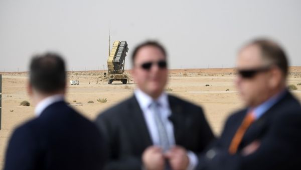 n this file photo taken on February 20, 2020 Security for US Secretary of State Mike Pompeo (L) is pictured near a Patriot missile battery as he visits the Prince Sultan air base in Al-Kharj, in central Saudi Arabia. The US is pulling out four of its powerful Patriot missile systems from Saudi Arabia, after determining the threat from Iran that sparked an arms buildup in the region last year had waned, a Defense Department official said May 7, 2020. ANDREW CABALLERO-REYNOLDS / AFP