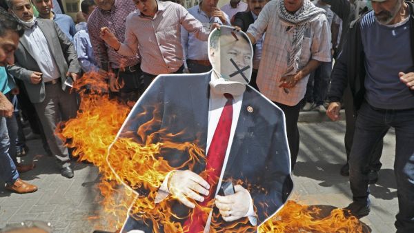 Palestinian men burn a cardboard cutout of US Secretary of State Mike Pompeo during a protest against his visit to Israel, on May 14, 2020 in Nablus in the occupied West Bank. Pompeo landed in Tel Aviv the day before for talks on regional security and Israel's plans to annex parts of the occupied West Bank, a pool report said. JAAFAR ASHTIYEH / AFP